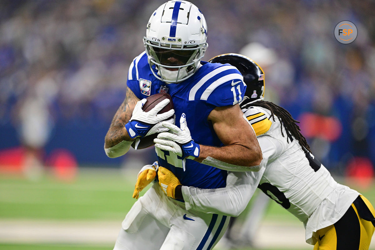 Sep 29, 2024; Indianapolis, Indiana, USA; Indianapolis Colts wide receiver Michael Pittman Jr. (11) is tackled by Pittsburgh Steelers cornerback Donte Jackson (26) during the second quarter at Lucas Oil Stadium. Credit: Marc Lebryk-Imagn Images