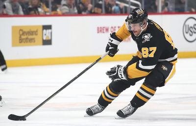 Feb 4, 2025; Pittsburgh, Pennsylvania, USA;  Pittsburgh Penguins center Sidney Crosby (87) handles the puck against the New Jersey Devils during the third period at PPG Paints Arena. Mandatory Credit: Charles LeClaire-Imagn Images