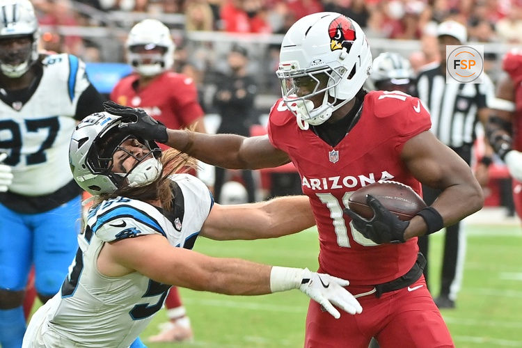 Sep 14, 2025; Glendale, Arizona, USA;  Arizona Cardinals wide receiver Marvin Harrison Jr. (18) runs the ball defended by Carolina Panthers linebacker Christian Rozeboom (56) during the third quarter at State Farm Stadium. Credit: Matt Kartozian-Imagn Images