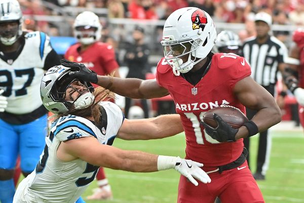 Sep 14, 2025; Glendale, Arizona, USA;  Arizona Cardinals wide receiver Marvin Harrison Jr. (18) runs the ball defended by Carolina Panthers linebacker Christian Rozeboom (56) during the third quarter at State Farm Stadium. Mandatory Credit: Matt Kartozian-Imagn Images