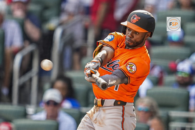 Jul 5, 2025; Cumberland, Georgia, USA; Baltimore Orioles center fielder Cedric Mullins (31) hits a double against the Atlanta Braves during the seventh inning at Truist Park. Credit: Dale Zanine-Imagn Images