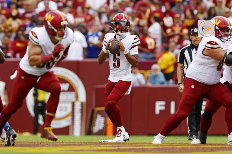 Sep 7, 2025; Landover, Maryland, USA; Washington Commanders quarterback Jayden Daniels (5) looks to pass the ball during the second quarter at Northwest Stadium. Credit: Peter Casey-Imagn Images