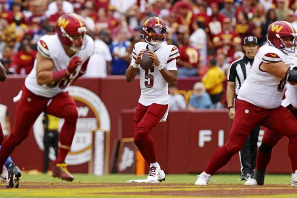 Sep 7, 2025; Landover, Maryland, USA; Washington Commanders quarterback Jayden Daniels (5) looks to pass the ball during the second quarter at Northwest Stadium. Mandatory Credit: Peter Casey-Imagn Images