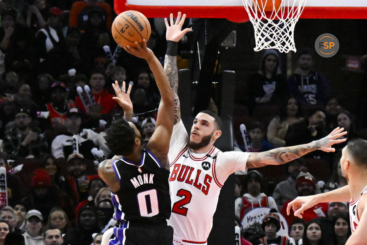 Jan 12, 2025; Chicago, Illinois, USA;  Chicago Bulls guard Lonzo Ball (2) defend against Sacramento Kings guard Malik Monk (0) during the first half at United Center. Credit: Matt Marton-Imagn Images