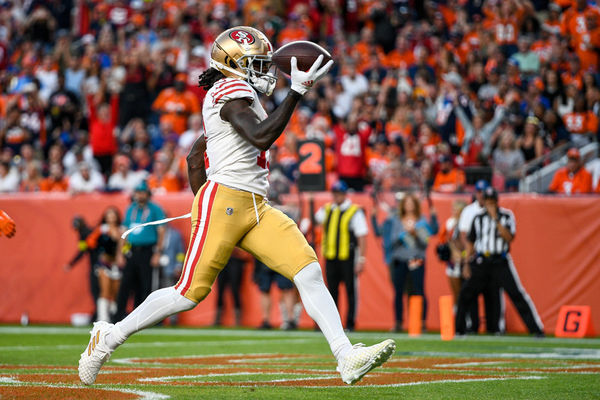 DENVER, CO - SEPTEMBER 25: San Francisco 49ers wide receiver Brandon Aiyuk (11) scores a first half touchdown after a reception against the Denver Broncos during a game between the San Francisco 49ers and the Denver Broncos at Empower Field at Mile High on September 25, 2022 in Denver, Colorado. (Photo by Dustin Bradford/Icon Sportswire)