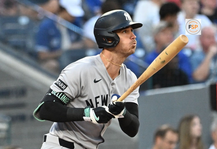 Jul 22, 2025; Toronto, Ontario, CAN;   New York Yankees left fielder Cody Bellinger (35) hits a double against the Toronto Blue Jays in the third inning at Rogers Centre. Credit: Dan Hamilton-Imagn Images