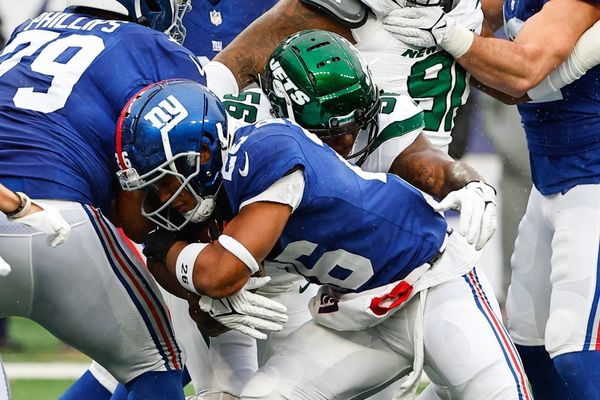 EAST RUTHERFORD, NJ - OCTOBER 29:   Quincy Williams (56) of the New York Jets tackles Saquon Barkley (26) of the New York Giants during the game on October 29, 2023 at MetLife Stadium in East Rutherford, New Jersey.  (Photo by Rich Graessle/Icon Sportswire)