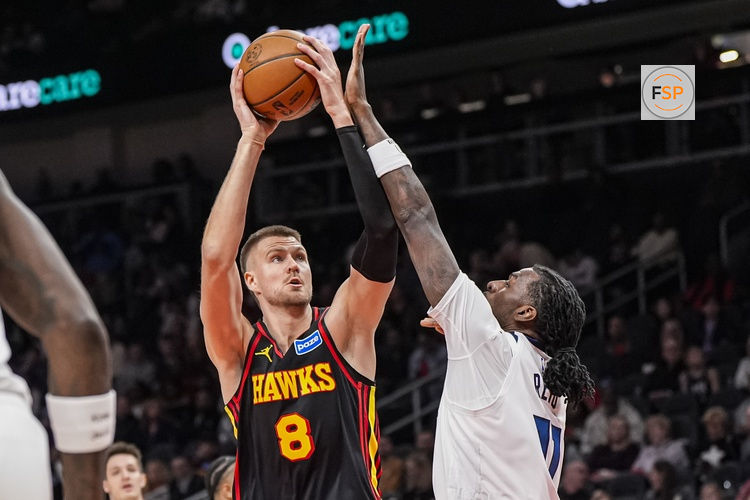 Dec 31, 2025; Atlanta, Georgia, USA; Atlanta Hawks center Kristaps Porzingis (8) shoots over Minnesota Timberwolves center Naz Reid (11) during the first half at State Farm Arena. Credit: Dale Zanine-Imagn Images