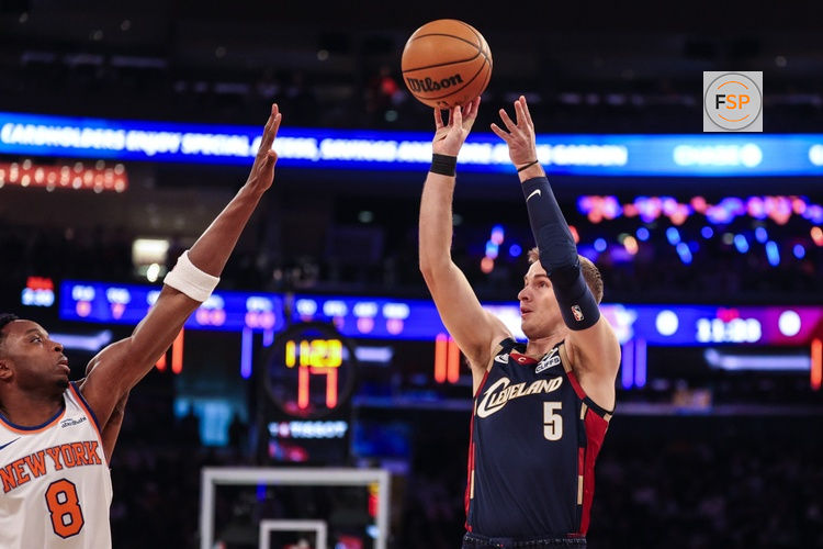 Dec 25, 2025; New York, New York, USA; Cleveland Cavaliers guard Sam Merrill (5) shoots the ball during the first quarter as New York Knicks forward Og Anunoby (8) defends at Madison Square Garden. Credit: Vincent Carchietta-Imagn Images