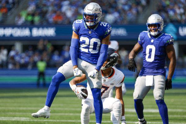 Sep 8, 2024; Seattle, Washington, USA; Seattle Seahawks safety Julian Love (20) celebrates after making a tackle against the Denver Broncos during the third quarter at Lumen Field. Mandatory Credit: Joe Nicholson-Imagn Images