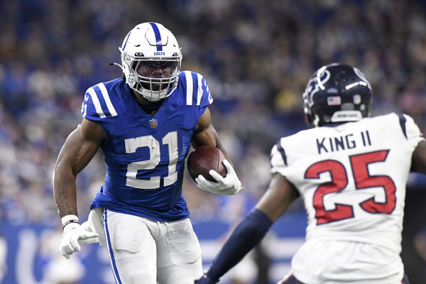 INDIANAPOLIS, IN - JANUARY 08: Indianapolis Colts running back Zack Moss (21) advances the ball as Houston Texans defensive back Desmond King II (25) defends during the game between the Houston Texans and the Indianapolis Colts on January 8, 2023, at Lucas Oil Stadium in Indianapolis, Indiana. (Photo by Michael Allio/Icon Sportswire)