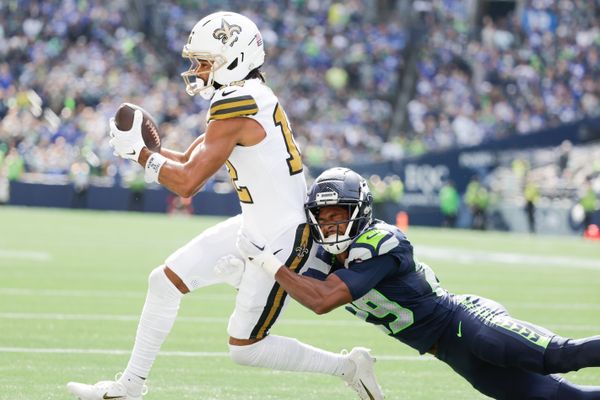 Sep 21, 2025; Seattle, Washington, USA; New Orleans Saints wide receiver Chris Olave (12) catches a pass against Seattle Seahawks cornerback Josh Jobe (29) during the first quarter  at Lumen Field. Mandatory Credit: Joe Nicholson-Imagn Images