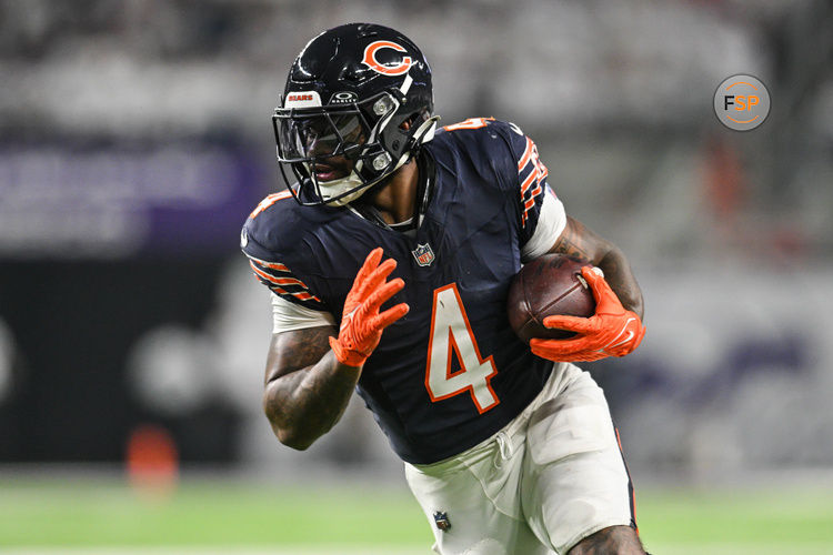 Dec 16, 2024; Minneapolis, Minnesota, USA; Chicago Bears running back D'Andre Swift (4) runs the ball against the Minnesota Vikings during the third quarter at U.S. Bank Stadium. Credit: Jeffrey Becker-Imagn Images