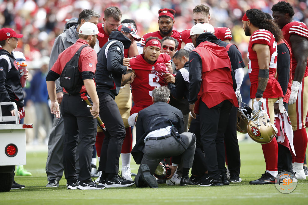 SANTA CLARA, CA - SEPTEMBER 18: Trey Lance #5 of the San Francisco 49ers gets helped off the field with a fractured ankle during the game against the Seattle Seahawks at Levi's Stadium on September 18, 2022 in Santa Clara, California. The 49ers defeated the Seahawks 27-7. (Photo by Michael Zagaris/San Francisco 49ers/Getty Images)  *** Local Caption *** Trey Lance