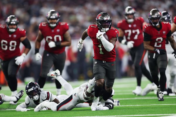 Sep 15, 2025; Houston, Texas, USA;Tampa Bay Buccaneers running back Rachaad White (1) rushes and breaks a tackle from Houston Texans linebacker Azeez Al-Shaair (0) during the third quarter at NRG Stadium. Mandatory Credit: Troy Taormina-Imagn Images