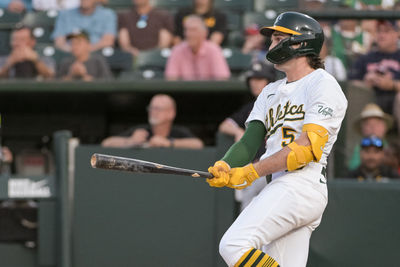 Jun 4, 2025; West Sacramento, California, USA; Athletics shortstop Jacob Wilson (5) hits a single against the Minnesota Twins during the third inning at Sutter Health Park. Mandatory Credit: Ed Szczepanski-Imagn Images