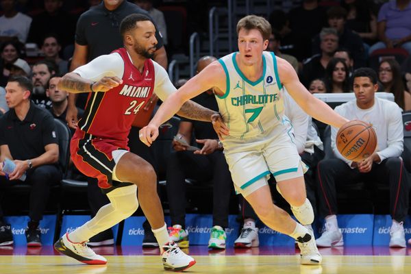 Nov 7, 2025; Miami, Florida, USA; Charlotte Hornets guard Kon Knueppel (7) drives to the basket against Miami Heat guard Norman Powell (24) during the first quarter of an NBA Cup game at Kaseya Center. Mandatory Credit: Sam Navarro-Imagn Images