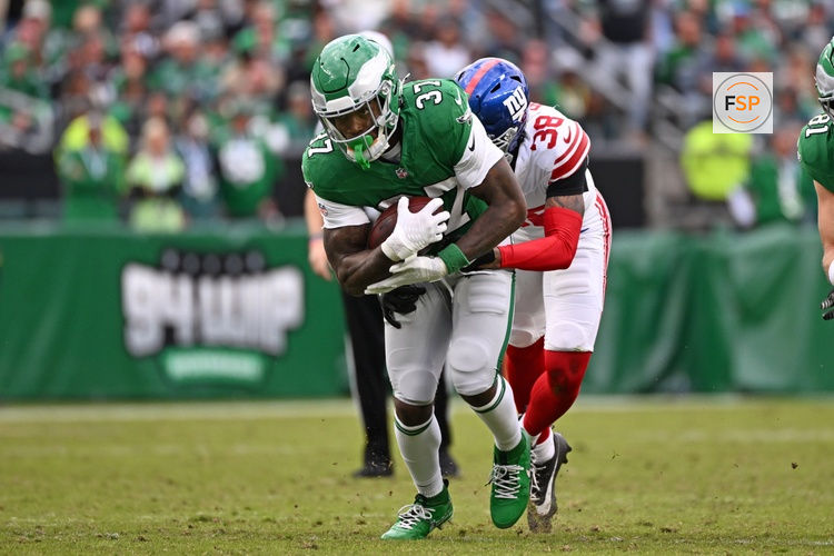 Oct 26, 2025; Philadelphia, Pennsylvania, USA; Philadelphia Eagles running back Tank Bigsby (37) is tackled by \g38\ during the third quarter at Lincoln Financial Field. Credit: Eric Hartline-Imagn Images