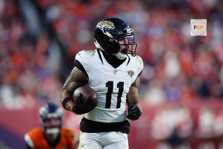 Dec 21, 2025; Denver, Colorado, USA; Jacksonville Jaguars wide receiver Parker Washington (11) makes a catch for a touchdown against the Denver Broncos during the second  half at Empower Field at Mile High. Credit: Ron Chenoy-Imagn Images