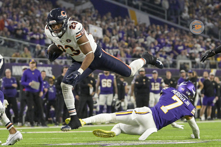 MINNEAPOLIS, MN - NOVEMBER 27: Chicago Bears running back Roschon Johnson (23) leaps over Minnesota Vikings defensive back Byron Murphy (7) during the second quarter of an NFL game between the Minnesota Vikings and Chicago Bears on November 27, 2023, at U.S. Bank Stadium in Minneapolis, MN. (Photo by Nick Wosika/Icon Sportswire)