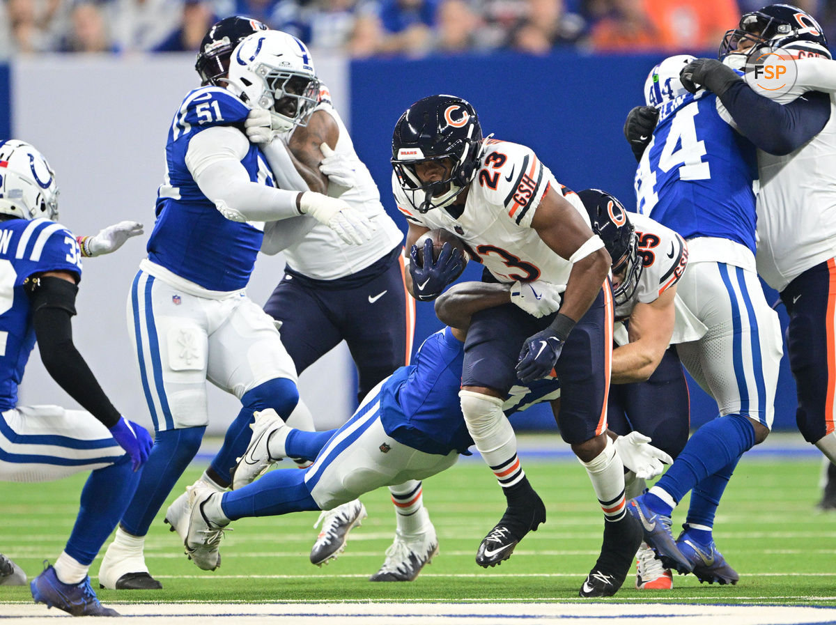 Sep 22, 2024; Indianapolis, Indiana, USA; Chicago Bears running back Roschon Johnson (23) is tackled by Indianapolis Colts linebacker Jaylon Carlies (57) during the first quarter at Lucas Oil Stadium. Credit: Marc Lebryk-Imagn Images

