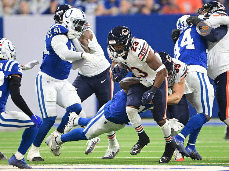 Sep 22, 2024; Indianapolis, Indiana, USA; Chicago Bears running back Roschon Johnson (23) is tackled by Indianapolis Colts linebacker Jaylon Carlies (57) during the first quarter at Lucas Oil Stadium. Credit: Marc Lebryk-Imagn Images

