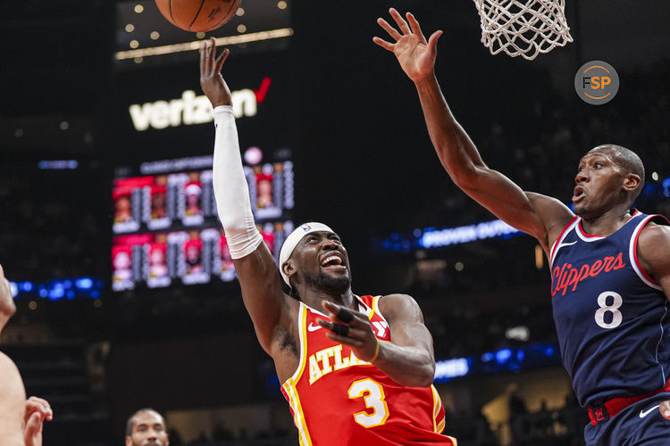 Mar 14, 2025; Atlanta, Georgia, USA; Atlanta Hawks guard Caris LeVert (3) shoots against  LA Clippers guard Kris Dunn (8) during the first half at State Farm Arena. Credit: Dale Zanine-Imagn Images