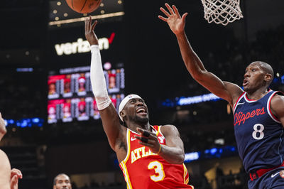 Mar 14, 2025; Atlanta, Georgia, USA; Atlanta Hawks guard Caris LeVert (3) shoots against  LA Clippers guard Kris Dunn (8) during the first half at State Farm Arena. Mandatory Credit: Dale Zanine-Imagn Images