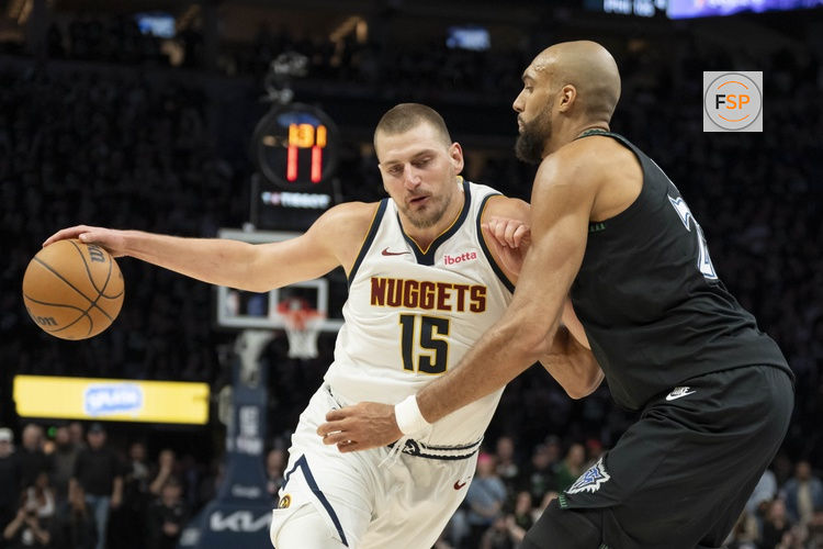 Apr 30, 2026; Minneapolis, Minnesota, USA; Denver Nuggets center Nikola Jokic (15) dribbles the ball as Minnesota Timberwolves center Rudy Gobert (27) played defense in the second half during game six of the first round of the 2026 NBA Playoffs at Target Center. Credit: Jesse Johnson-Imagn Images