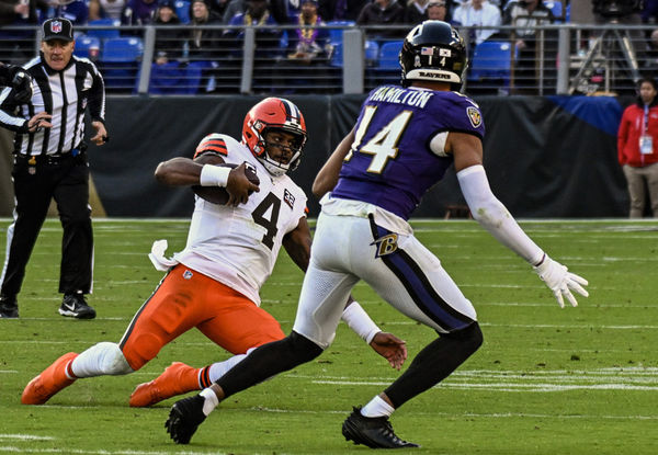 BALTIMORE, MD - NOVEMBER 12:  Cleveland Browns quarterback Deshaun Watson (4) slides to avoid the tackle for Baltimore Ravens safety Kyle Hamilton (14) during the Cleveland Browns game versus the Baltimore Ravens on November 12, 2023 at M&T Bank Stadium in Baltimore, MD.  (Photo by Mark Goldman/Icon Sportswire)