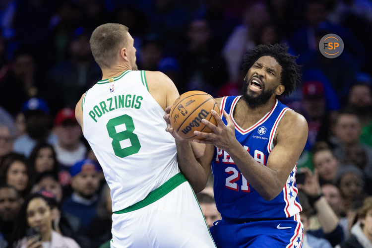 Feb 20, 2025; Philadelphia, Pennsylvania, USA; Philadelphia 76ers center Joel Embiid (21) is fouled by Boston Celtics center Kristaps Porzingis (8) during the second quarter at Wells Fargo Center. Credit: Bill Streicher-Imagn Images