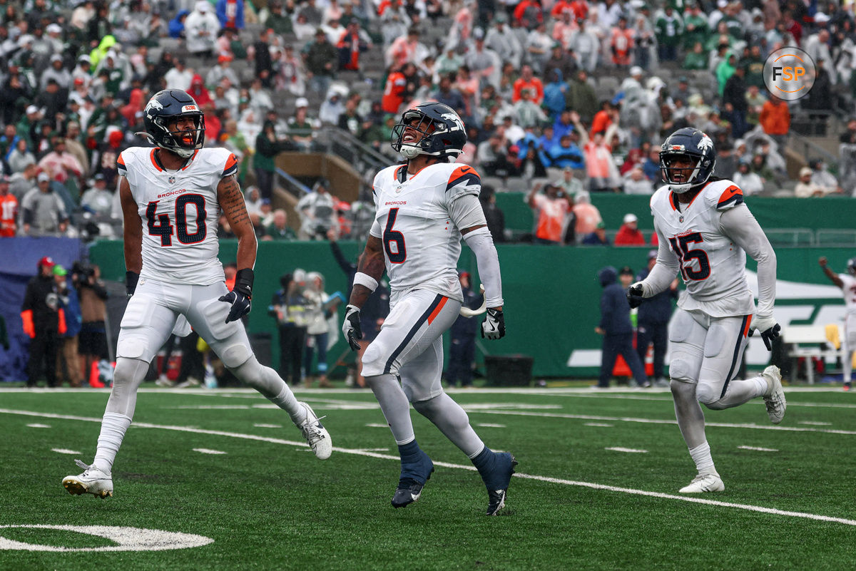 Sep 29, 2024; East Rutherford, New Jersey, USA; Denver Broncos safety P.J. Locke (6) celebrates a fourth quarter, fourth down defensive stop with linebacker Justin Strnad (40) and linebacker Nik Bonitto (15) during the second half against the New York Jets at MetLife Stadium. Credit: Vincent Carchietta-Imagn Images