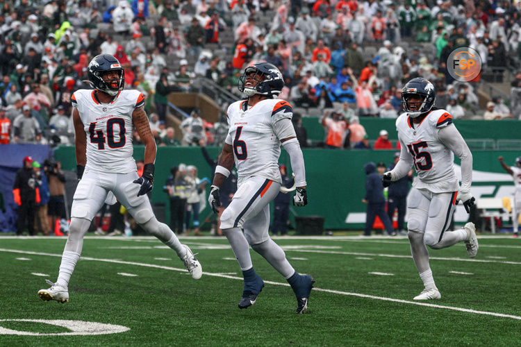 Sep 29, 2024; East Rutherford, New Jersey, USA; Denver Broncos safety P.J. Locke (6) celebrates a fourth quarter, fourth down defensive stop with linebacker Justin Strnad (40) and linebacker Nik Bonitto (15) during the second half against the New York Jets at MetLife Stadium. Credit: Vincent Carchietta-Imagn Images