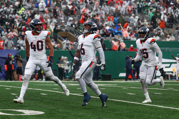 Sep 29, 2024; East Rutherford, New Jersey, USA; Denver Broncos safety P.J. Locke (6) celebrates a fourth quarter, fourth down defensive stop with linebacker Justin Strnad (40) and linebacker Nik Bonitto (15) during the second half against the New York Jets at MetLife Stadium. Mandatory Credit: Vincent Carchietta-Imagn Images