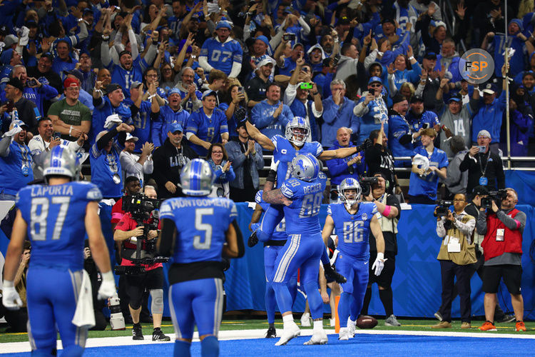 DETROIT, MI - JANUARY 21:  Detroit Lions wide receiver Amon-Ra St. Brown (14) is hoisted into the air by Detroit Lions offensive tackle Taylor Decker (68) after catching a touchdown pass during an NFL NFC Divisional playoff football game between the Tampa Bay Buccaneers and the Detroit Lions on January 21, 2024 at Ford Field in Detroit, Michigan. (Photo by Scott W. Grau/Icon Sportswire)