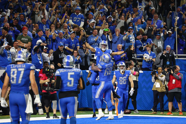 DETROIT, MI - JANUARY 21:  Detroit Lions wide receiver Amon-Ra St. Brown (14) is hoisted into the air by Detroit Lions offensive tackle Taylor Decker (68) after catching a touchdown pass during an NFL NFC Divisional playoff football game between the Tampa Bay Buccaneers and the Detroit Lions on January 21, 2024 at Ford Field in Detroit, Michigan. (Photo by Scott W. Grau/Icon Sportswire)