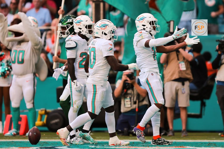 Dec 8, 2024; Miami Gardens, Florida, USA; Miami Dolphins wide receiver Jaylen Waddle (17) celebrates with wide receiver Tyreek Hill (10) after scoring a touchdown against the New York Jets during the fourth quarter at Hard Rock Stadium. Credit: Sam Navarro-Imagn Images