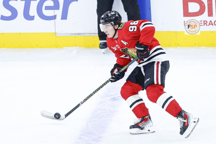 Nov 18, 2025; Chicago, Illinois, USA; Chicago Blackhawks center Connor Bedard (98) looks to pass the puck against the Calgary Flames during the third period at United Center. Credit: Kamil Krzaczynski-Imagn Images
