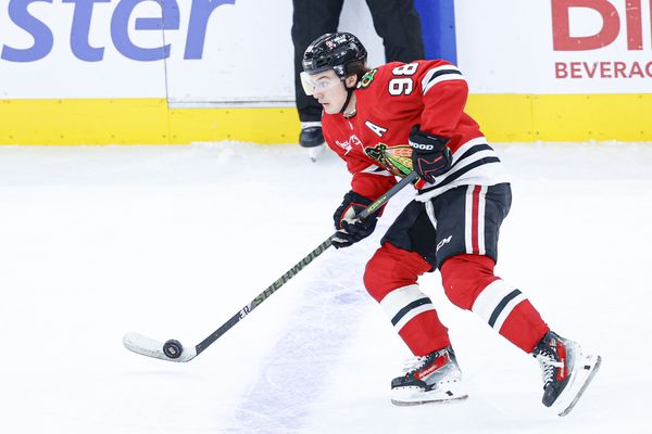 Nov 18, 2025; Chicago, Illinois, USA; Chicago Blackhawks center Connor Bedard (98) looks to pass the puck against the Calgary Flames during the third period at United Center. Mandatory Credit: Kamil Krzaczynski-Imagn Images