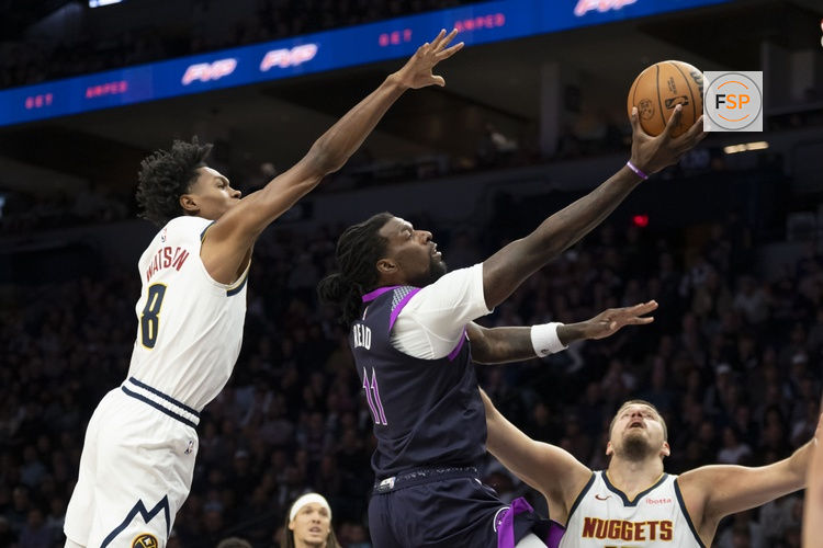 Nov 15, 2025; Minneapolis, Minnesota, USA; Minnesota Timberwolves center Naz Reid (11) drives to the basket past Denver Nuggets guard Peyton Watson (8) in the first half at Target Center. Credit: Jesse Johnson-Imagn Images