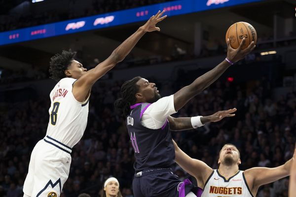 Nov 15, 2025; Minneapolis, Minnesota, USA; Minnesota Timberwolves center Naz Reid (11) drives to the basket past Denver Nuggets guard Peyton Watson (8) in the first half at Target Center. Mandatory Credit: Jesse Johnson-Imagn Images