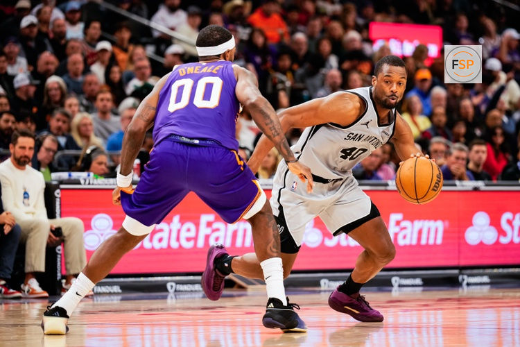 Nov 23, 2025; Phoenix, Arizona, USA;  San Antonio Spurs forward Harrison Barnes (40) dribbles against Phoenix Suns forward Royce O'Neale (00) in the second half of the game at Mortgage Match Up Center. Credit: Arianna Grainey-Imagn Images