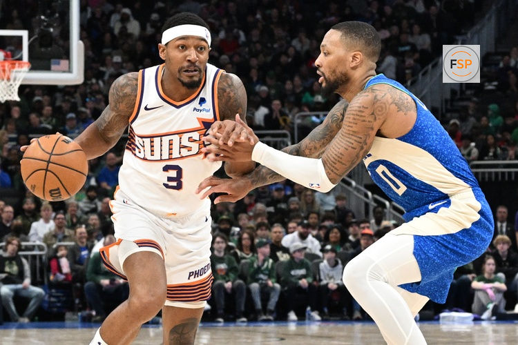 Mar 17, 2024; Milwaukee, Wisconsin, USA; Phoenix Suns guard Bradley Beal (3) drives against Milwaukee Bucks guard Damian Lillard (0) on the second half at Fiserv Forum. Credit: Michael McLoone-USA TODAY Sports