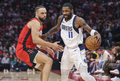 Jan 1, 2025; Houston, Texas, USA; Dallas Mavericks guard Kyrie Irving (11) controls the ball as Houston Rockets forward Dillon Brooks (9) defends during the third quarter at Toyota Center. Mandatory Credit: Troy Taormina-Imagn Images