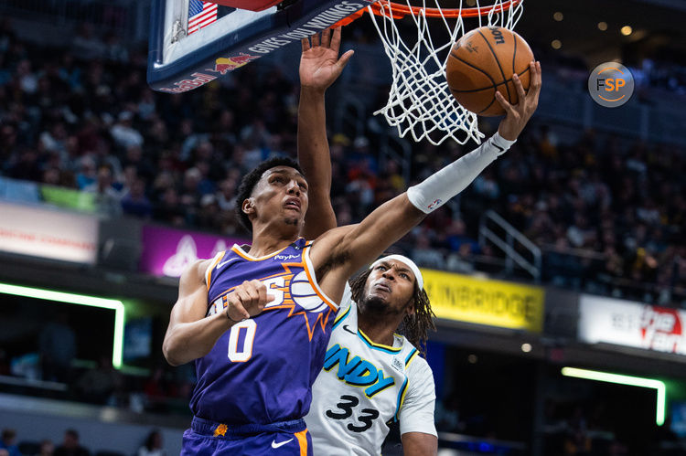 Jan 4, 2025; Indianapolis, Indiana, USA; Phoenix Suns forward Ryan Dunn (0) shoots the ball against Indiana Pacers center Myles Turner (33) in the first half at Gainbridge Fieldhouse. Credit: Trevor Ruszkowski-Imagn Images