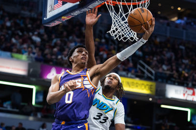 Jan 4, 2025; Indianapolis, Indiana, USA; Phoenix Suns forward Ryan Dunn (0) shoots the ball against Indiana Pacers center Myles Turner (33) in the first half at Gainbridge Fieldhouse. Mandatory Credit: Trevor Ruszkowski-Imagn Images