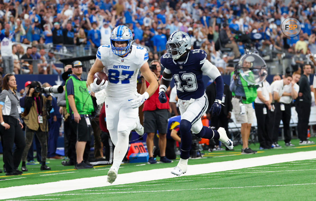 Oct 13, 2024; Arlington, Texas, USA;  Detroit Lions tight end Sam LaPorta (87) catches a pass past Dallas Cowboys linebacker DeMarvion Overshown (13) and scores a touchdown during the second quarter at AT&T Stadium. Credit: Kevin Jairaj-Imagn Images