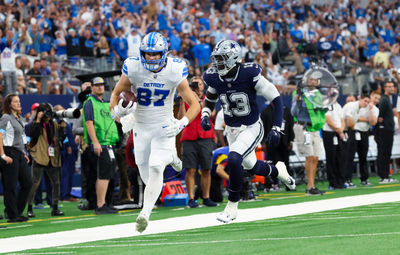 Oct 13, 2024; Arlington, Texas, USA;  Detroit Lions tight end Sam LaPorta (87) catches a pass past Dallas Cowboys linebacker DeMarvion Overshown (13) and scores a touchdown during the second quarter at AT&T Stadium. Mandatory Credit: Kevin Jairaj-Imagn Images