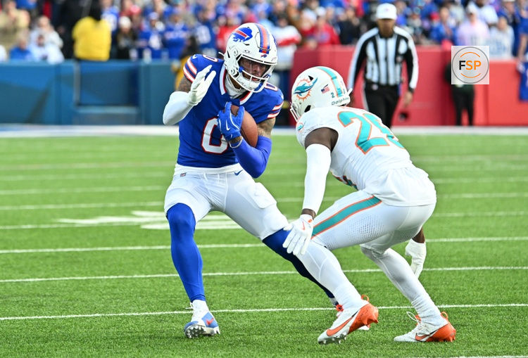 Nov 3, 2024; Orchard Park, New York, USA; Buffalo Bills wide receiver Keon Coleman (0) tries to avoid a tackle by Miami Dolphins safety Marcus Maye (26) in the fourth quarter at Highmark Stadium. Credit: Mark Konezny-Imagn Images