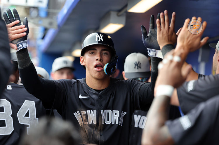 Feb 22, 2025; Dunedin, Florida, USA;  New York Yankees shortstop George Lombard Jr. (96)  is congratulated after he scored a run during the sixth inning against the Toronto Blue Jays at TD Ballpark. Credit: Kim Klement Neitzel-Imagn Images